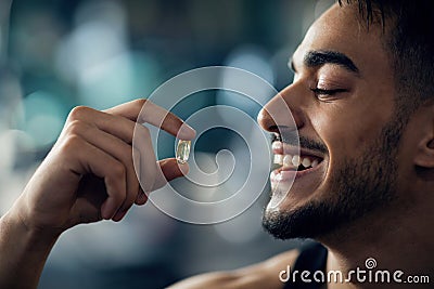 Best Multivitamins. Portrait Of Handsome Young Arab Guy Holding Supplement Capsule Stock Photo