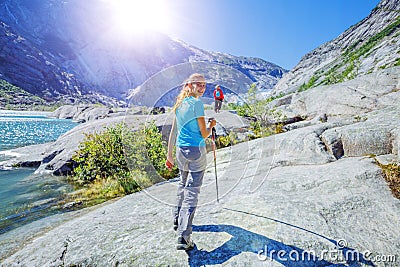 Best Norway hike. Cute girl with hiking equipment in the mountains Stock Photo