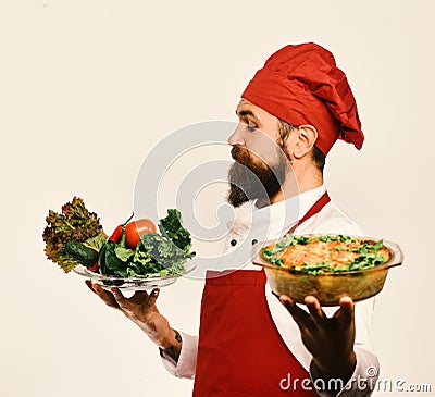 Best salads from chef. Handsome waiter or cook in uniform Stock Photo