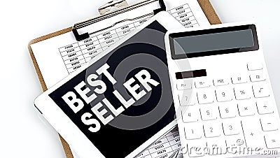 BEST SELLER text on a tablet with chart, calculator and pen Stock Photo