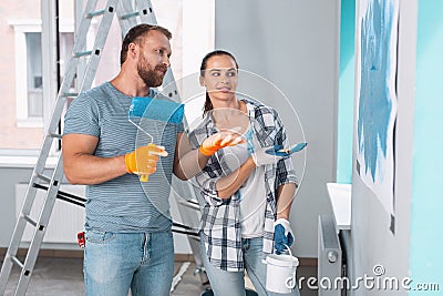 Happy painters discussing painting walls Stock Photo