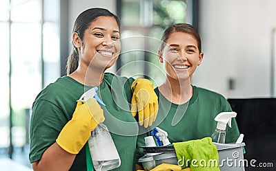 The best team to keep your office clean. Portrait of two young woman cleaning a modern office. Stock Photo