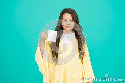 The best to drink in morning. happy girl with tea cup. good morning drink. small kid blue wall. little girl drink cocoa Stock Photo