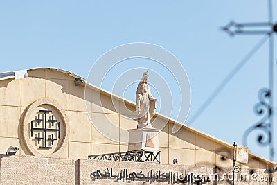 Stone statue of the Virgin Mary above the entrance to Eglise Syriaque Catholique Saint Joseph in Bethlehem in the Palestinian Editorial Stock Photo