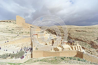 Bethlehem, Israel. - February 14.2017. View of the Lavra of Sawa Sanctified in the Judean Desert - many pilgrims at the entrance. Editorial Stock Photo