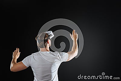 Occupied smart man standing and examining new gadget. Stock Photo