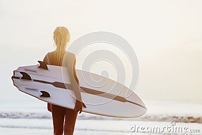 A beuatiful and sexy surfer girl at the beach Stock Photo