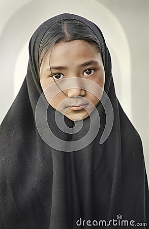 Beutiful girl with scarf and long black shawl inside a suni mosque Editorial Stock Photo