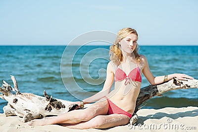 Beutiful young blond woman sunbatching on a beach Stock Photo