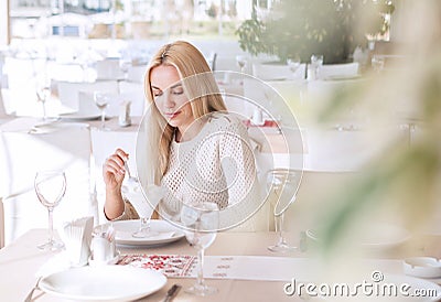 Beutiful young woman in cafe in sunny day Stock Photo