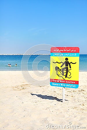 Beware with jellyfish warning sign on a beach. Stock Photo