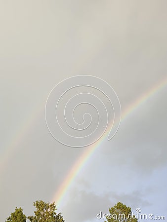 Beyond Horizons: Nature's Double Rainbow Stretches Wide Stock Photo