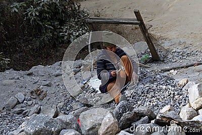 Bhojpur , Nepal - January 10, 2023 : Indian male and female workers digging and carrying out soil at buliding construction site. Editorial Stock Photo