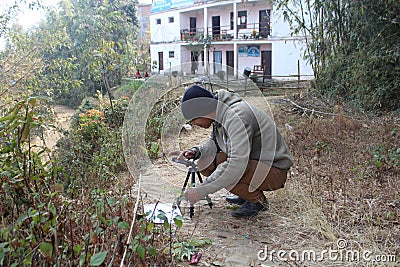 Bhojpur , Nepal - January 10, 2023, A Photographer from Nepal is taking photo Editorial Stock Photo