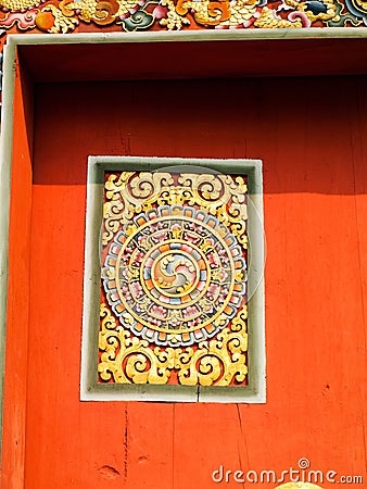Bhutan traditional carved wooden decoration on red door Stock Photo