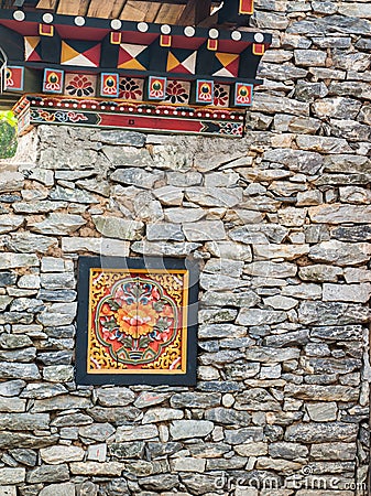 Bhutan traditional wooden decoration in rock wall Stock Photo