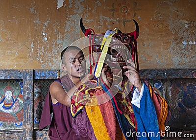 A Bhutanese monk makes up as buffalo head god for lama dance . Bumthang, central Bhutan. Editorial Stock Photo