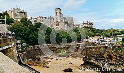 Tourists near the Church Sainte-Eugenie and Rocher Du Basta island Editorial Stock Photo