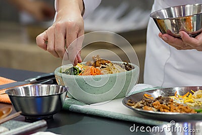Bibimbap, Traditional Korean cuisine bibimbap, Chef preparing Korean food, chef cooking in kitchen Stock Photo