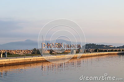 Bibinie, D-Marina, Croatia - sept 9 2018: Logo at the etnrance in mediterranean marina near Sukosan town. The boat of police or Editorial Stock Photo