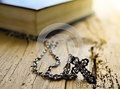 Bible book cross silver chain Scripture Biblical faith belief Stock Photo