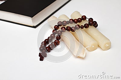 Bible book and rosary with three candle Stock Photo