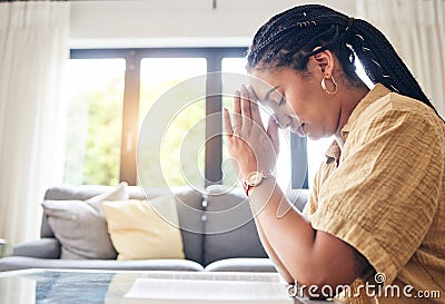 Bible, worship and woman praying in her living room for hope, help or forgiveness at home. Hands, book and Christian Stock Photo