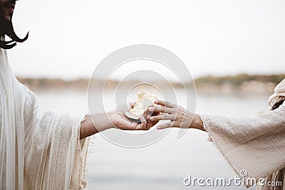 Biblical scene - of Jesus Christ handing out bread with a blurred background Stock Photo