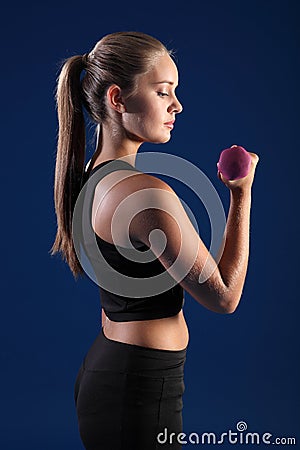 Bicep curl by beautiful young fitness woman Stock Photo