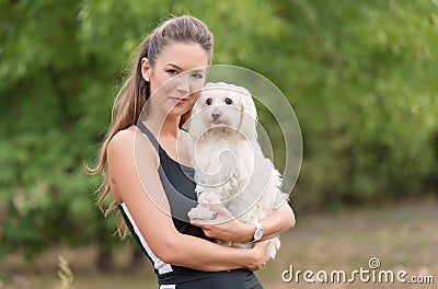 Bichon bolognese dog with beautiful woman in the park Stock Photo