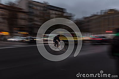 Bicicle rider riding fast in the big city Editorial Stock Photo