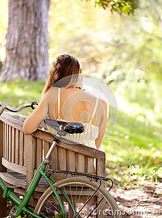 Bicycle, bench or woman in park to relax for wellness, nature or health on holiday vacation in autumn. Amsterdam, back Stock Photo