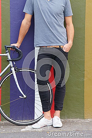 Bicycle, city wall and person travel, commute or a ride in the morning on the road. Fashion, sidewalk and a rider with a Stock Photo