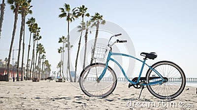 Bicycle cruiser bike by ocean beach, California coast USA. Summer cycle, lifeguard hut and palm tree Stock Photo
