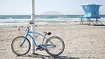 Bicycle cruiser bike by ocean beach California coast USA. Summer sea shore. Cycle by lifeguard tower Stock Photo