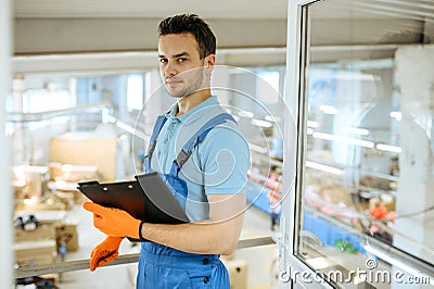 Bicycle factory, young worker with notebook Stock Photo