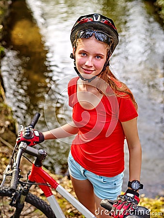 Bicycle girl cycling fording throught water . Stock Photo