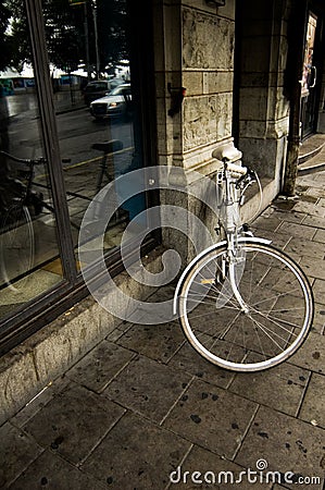 Bicycle leaning on building Stock Photo