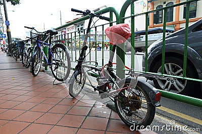 Bicycle locked in the fence of Singapore Editorial Stock Photo