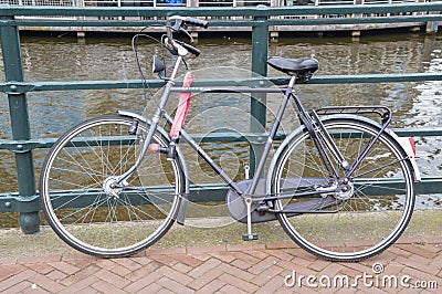 Bicycle Locked At A Gate At Amsterdam The Netherlands Editorial Stock Photo