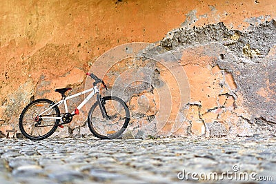 Bicycle near a stone wall Stock Photo