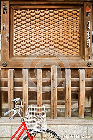 Bicycle Parked Outside Wooden Shrine Stock Photo