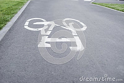 Bicycle path. Bicycle symbol on street. White bicycle sign on asphalt bike lane Stock Photo
