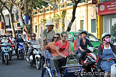 Bicycle rickshaw carries travelers in Ho Chi Minh City, Saigon. Vietnam Editorial Stock Photo