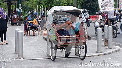 Rickshaws on Jalan Malioboro are a mode of transportation in Yogyakarta Indonesia: Yogyakarta-Indonesia, December 27, 2022 Editorial Stock Photo