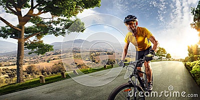 Bicycle rider cycle in Village hills nature landscape. road in motion bluring Stock Photo