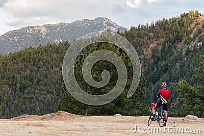 Bicycle rider and rocky mountain view Stock Photo