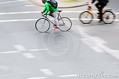 bicycle riders crossing an intersection Stock Photo