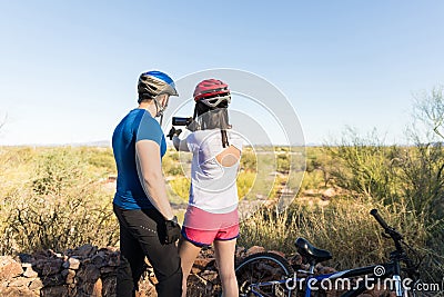 Bicycle Riders Exploring And Capturing Nature Stock Photo