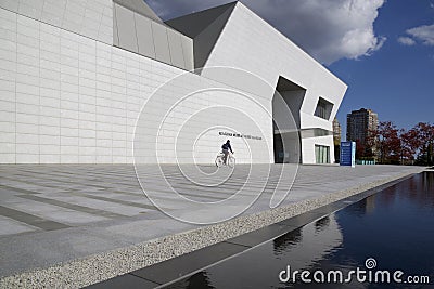 Bicycle riding in the exterior of the contemporary building with fall color Editorial Stock Photo